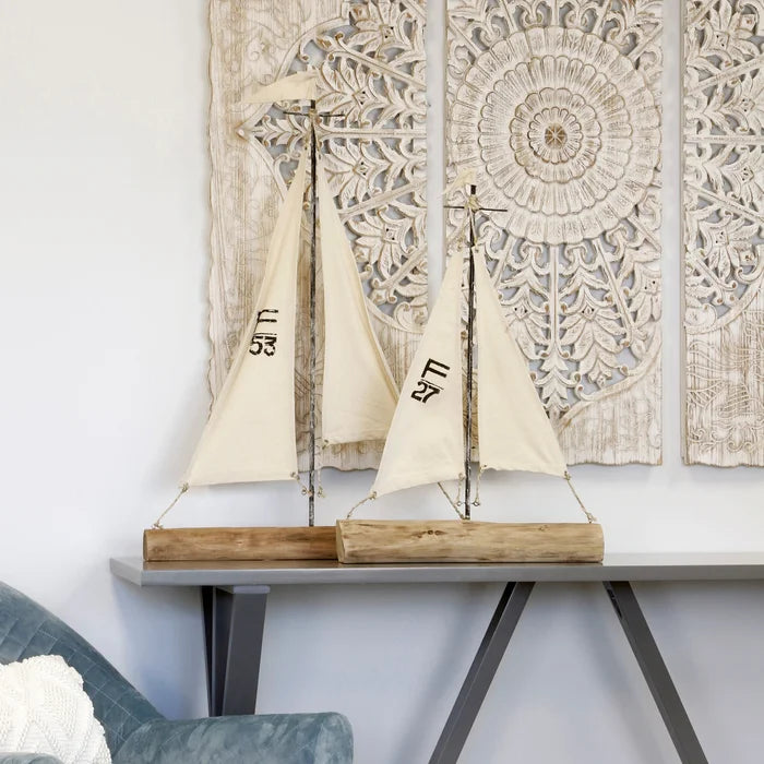 Natural wood metal and painted canvas sail boats